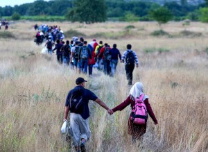 Migrants pass through the border from Greece into Macedonia near the town of Idomeni, Northern Greece, on Aug. 22. (Sakis Mitroldis/AFP/Getty Images)